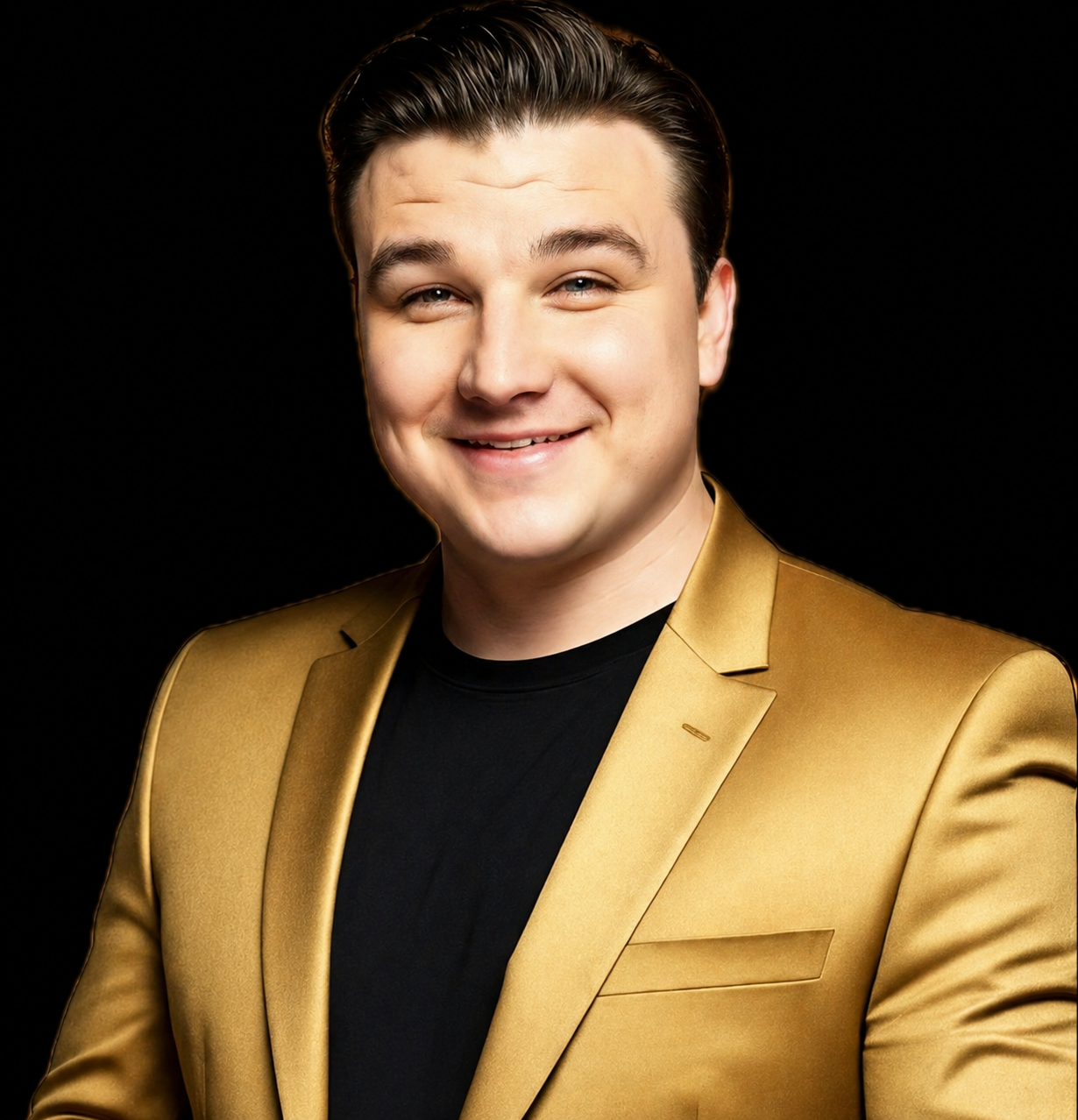 Man in a gold blazer smiling at the camera against a black background.