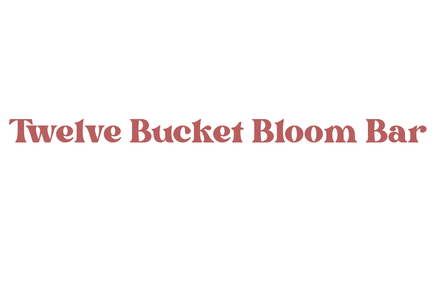 Logo for Twelve Bucket Bloom Bar, featuring a large flower illustration at the top, and the name "Twelve Bucket Bloom Bar" written in pinkish-brown text.