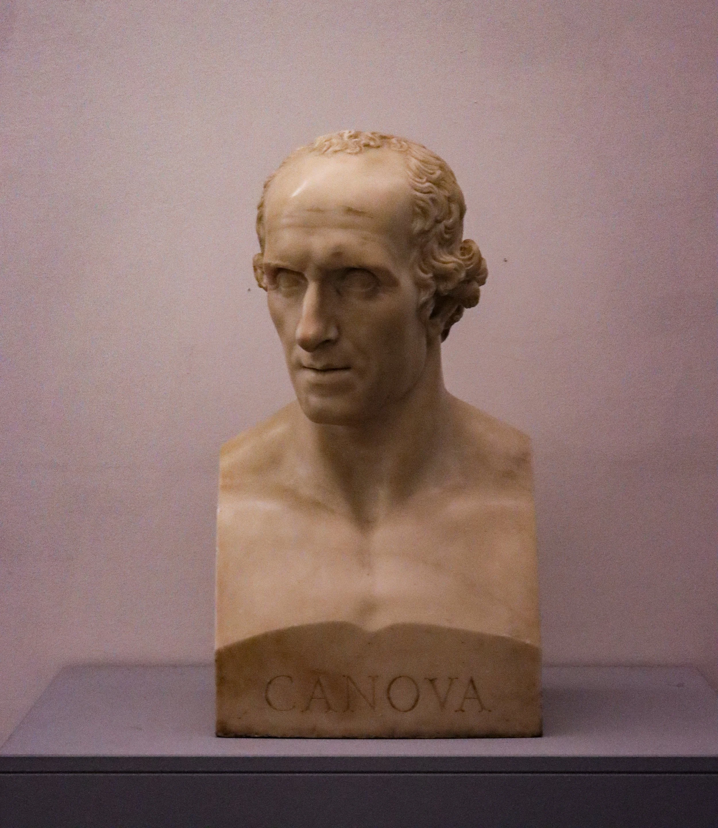 Marble bust sculpture of a woman with a lettered base that says 'CANTOVA.'
