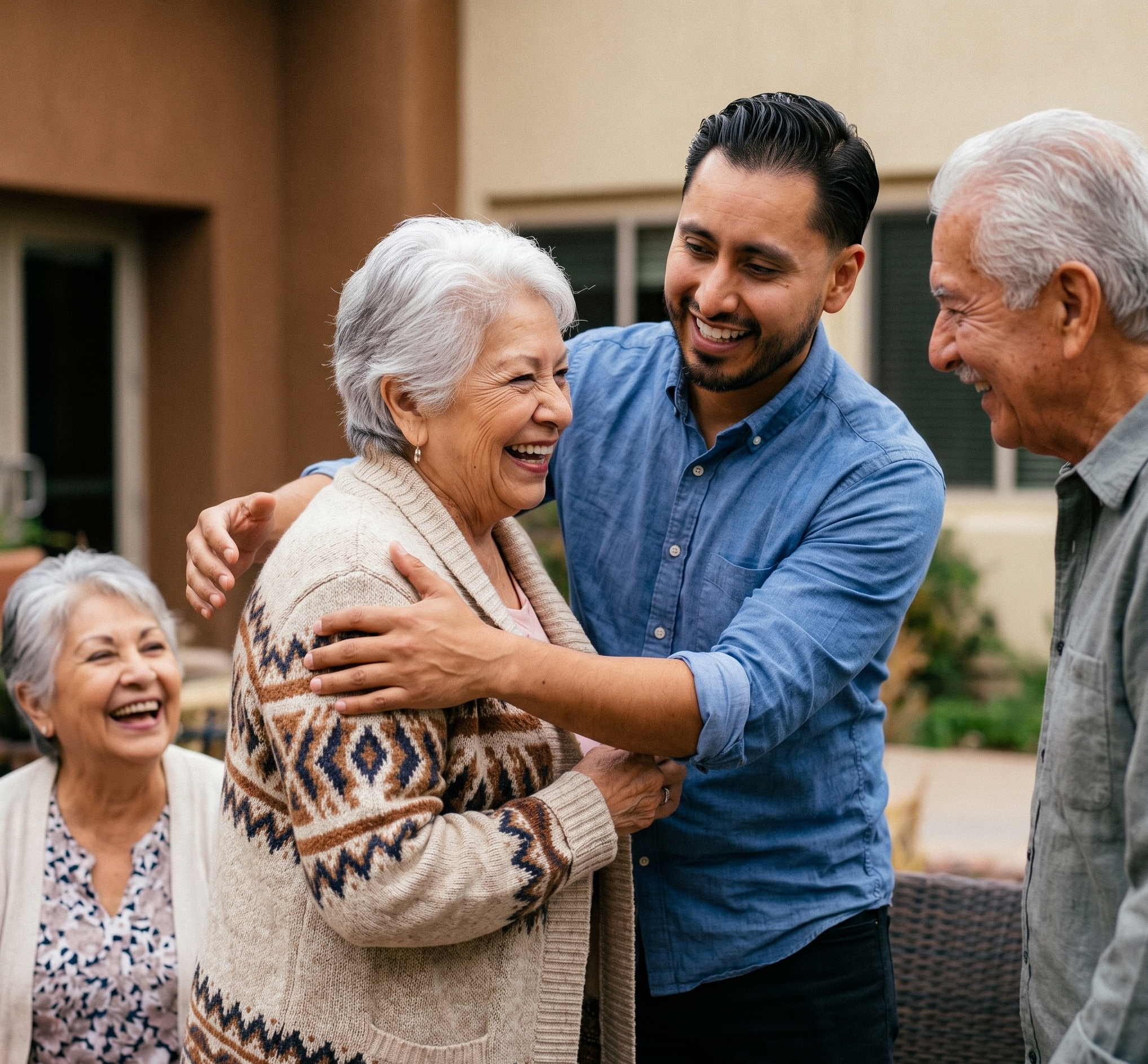 A group of elderly women and a younger man sharing a joyful moment outdoors, embracing and smiling.