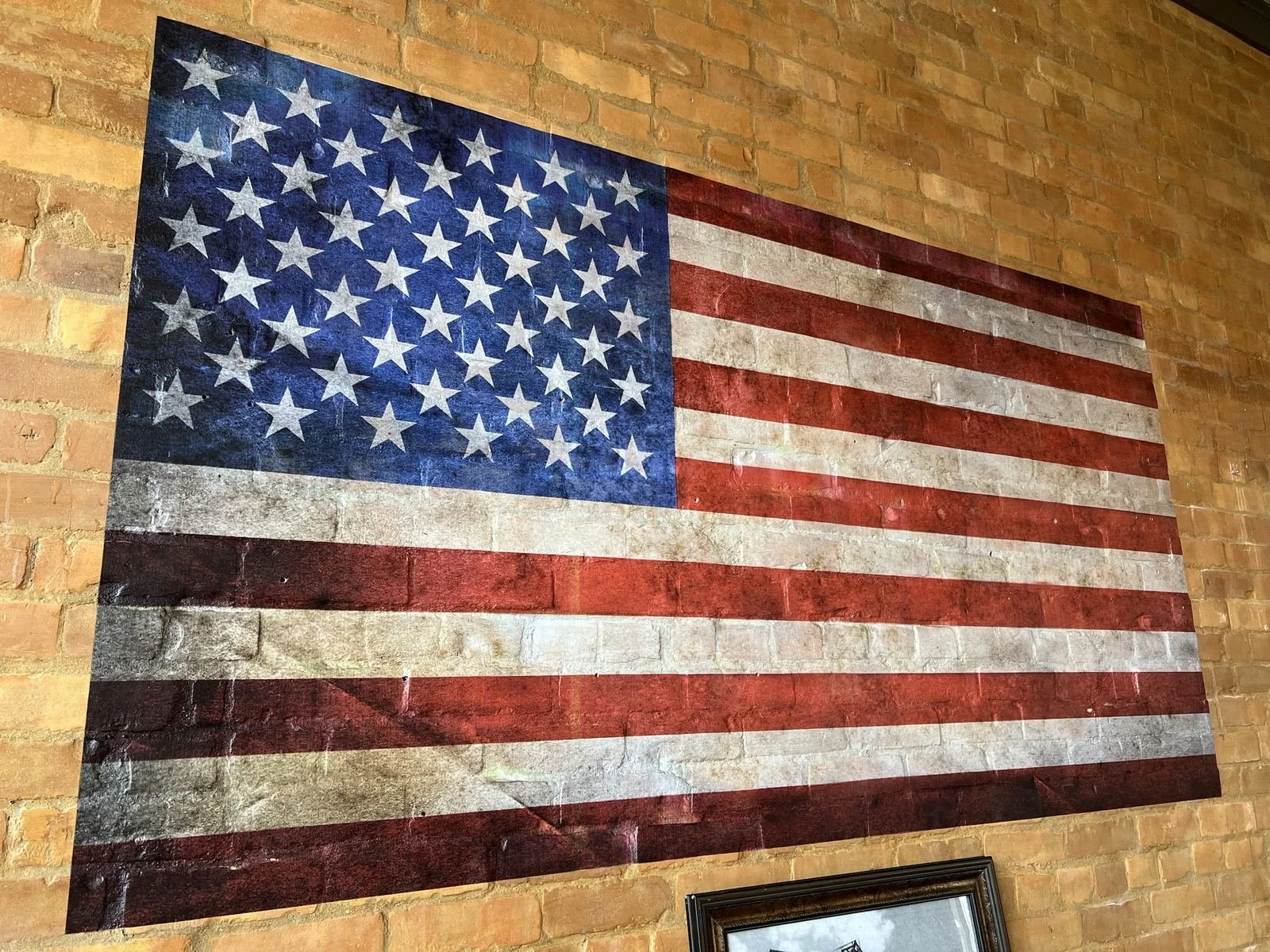 Completed American flag mural printed directly onto exposed brick in a Salt Lake City restaurant