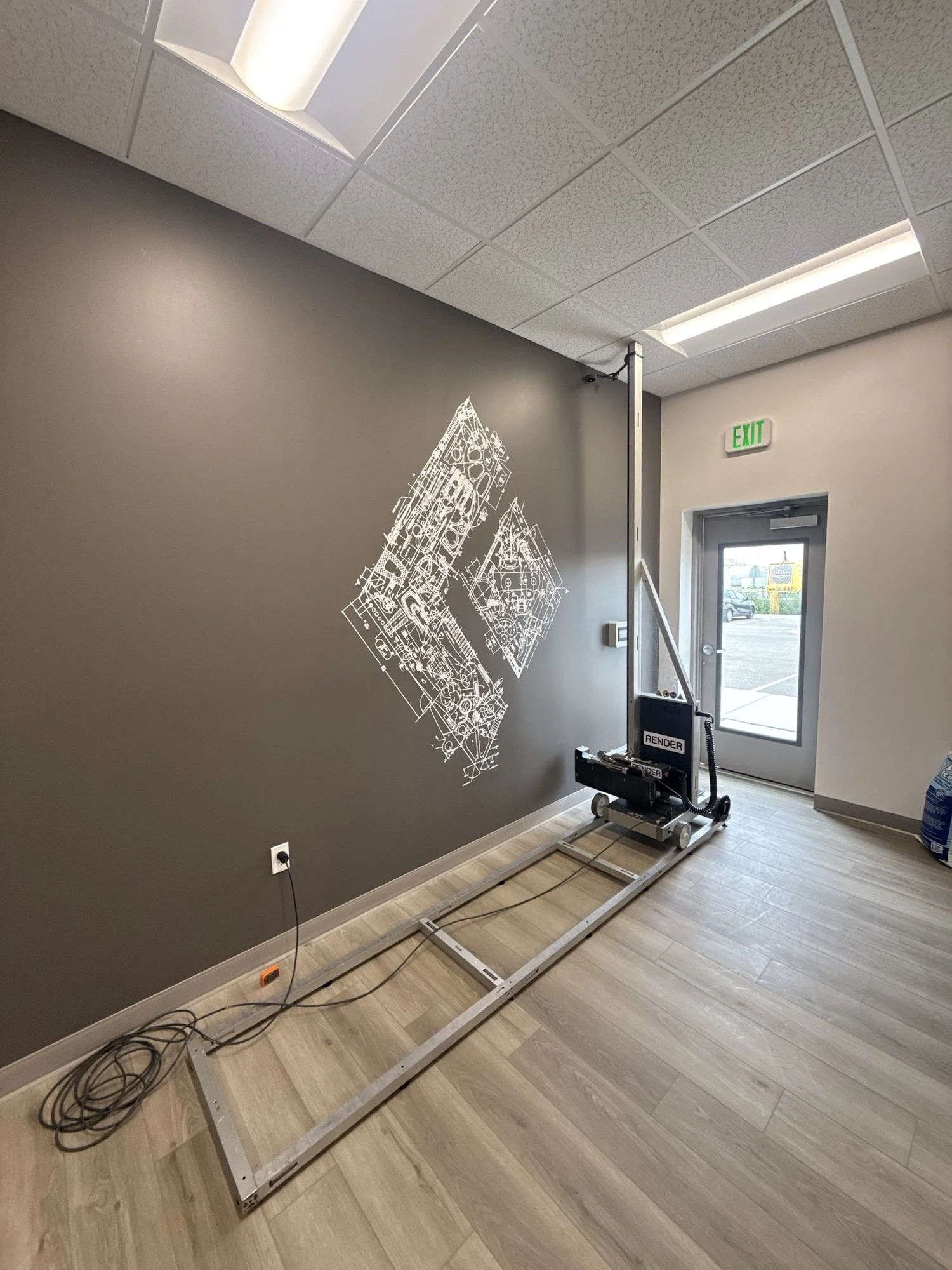 Render printer applying the Black Diamond logo to an interior wall in Salt Lake City