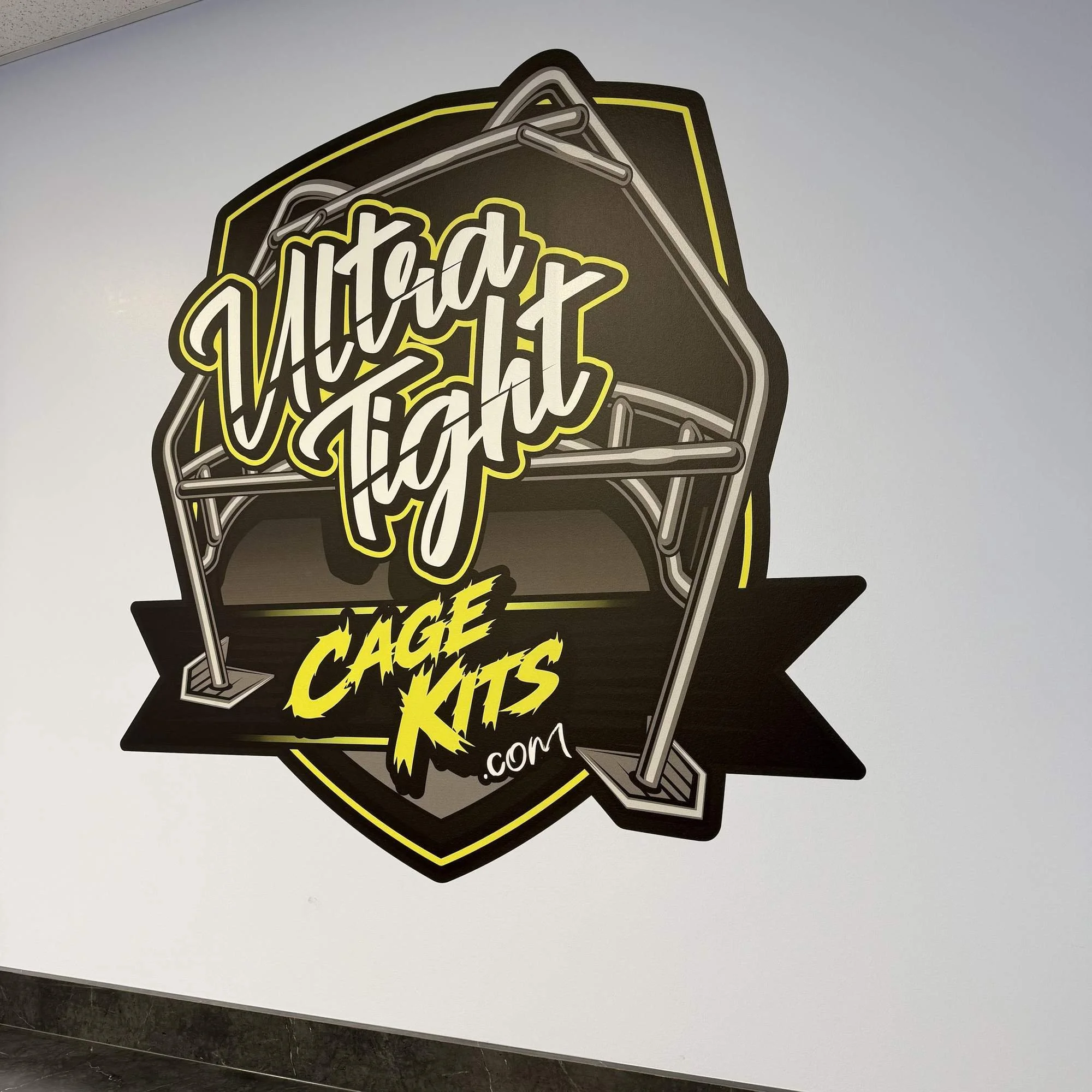 Ultra Tight Cage Kits logo printed directly onto an office wall in Salt Lake City