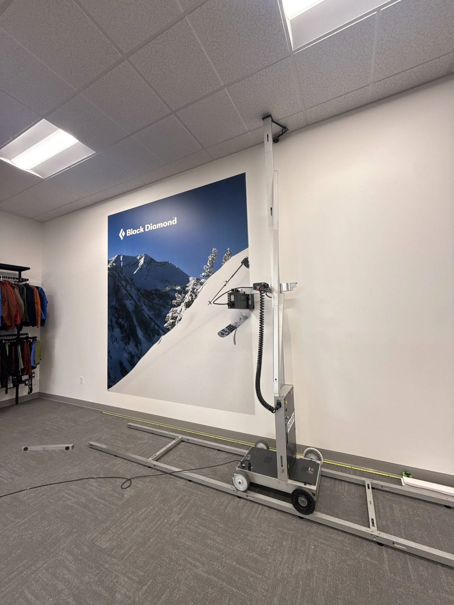 Render printer applying the Black Diamond logo to an interior wall in Salt Lake City