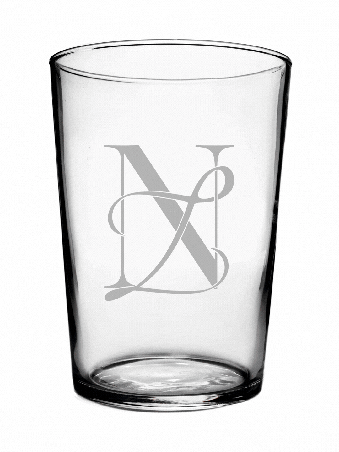 A clear glass tumbler with a gray monogram logo featuring the letters N, V, and L intertwined.