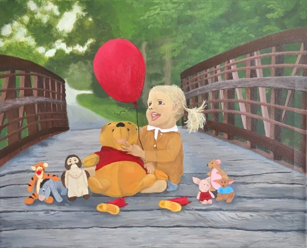 A young girl with blonde hair, wearing a tan coat, sitting on a wooden bridge, holding a red balloon and hugging Winnie the Pooh. Surrounding them are plush toys of Tigger, Eeyore, Owl, Piglet, Roo, and Kanga, with trees and greenery in the backgroun