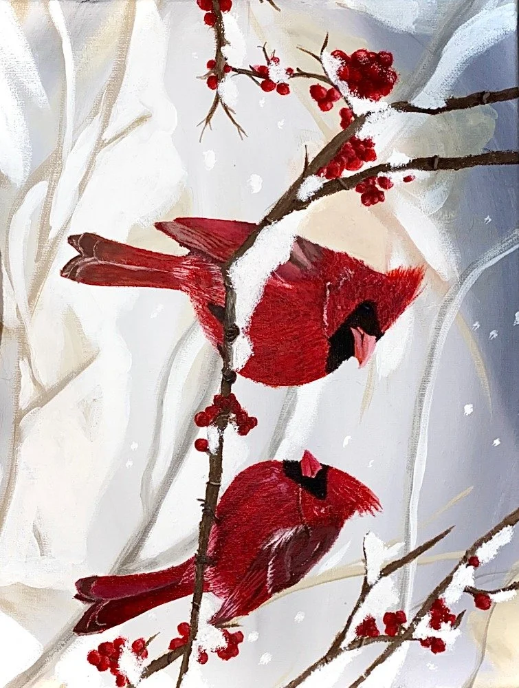 Two red cardinals perched on snow-covered branches with red berries, set against a snowy background.