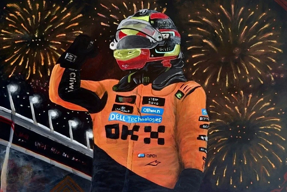 Race car driver celebrating with fireworks in the background, wearing an orange racing suit and helmet.