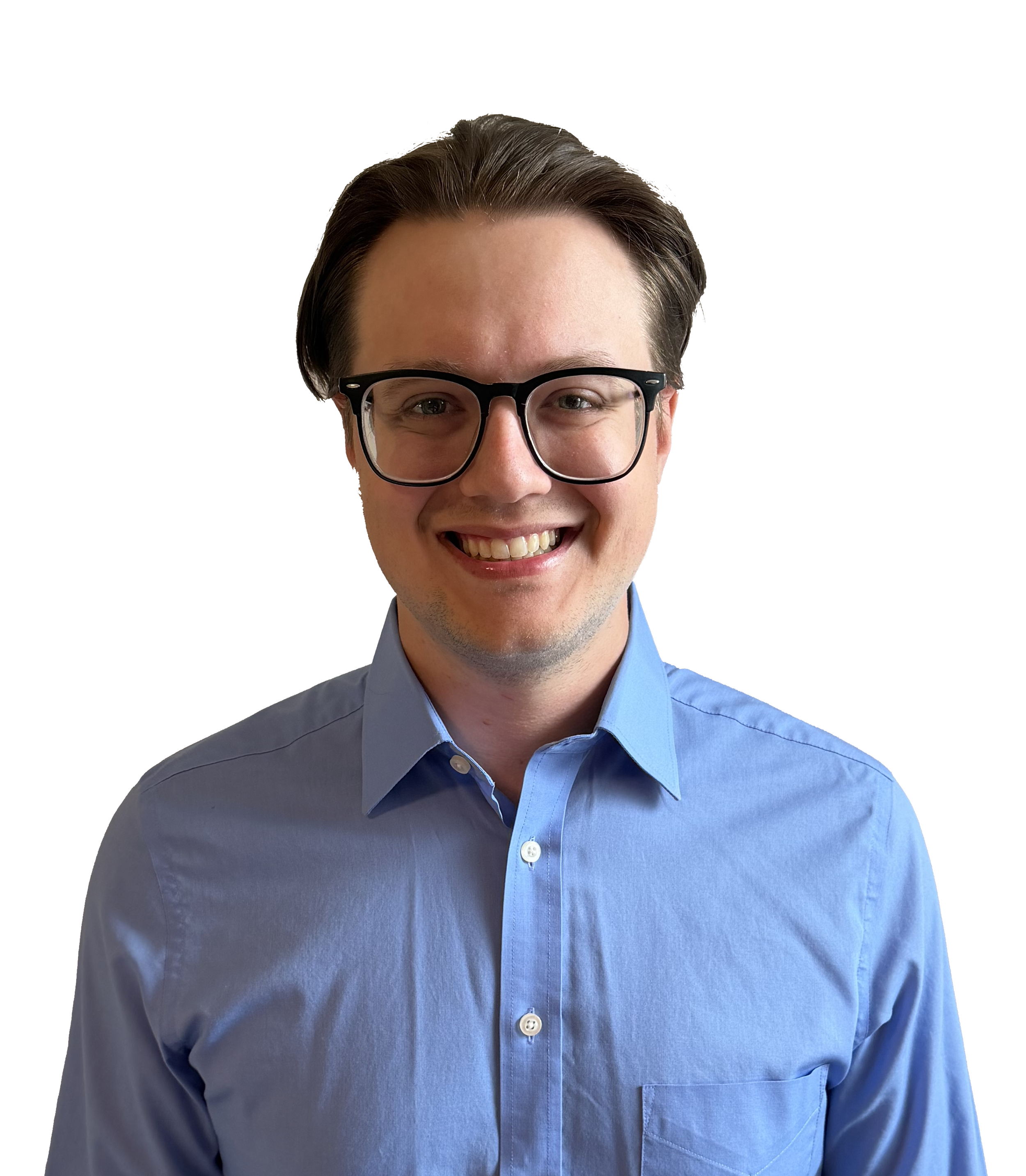 Close-up of a smiling man with light skin, brown hair, wearing round black glasses and a light blue collared shirt.