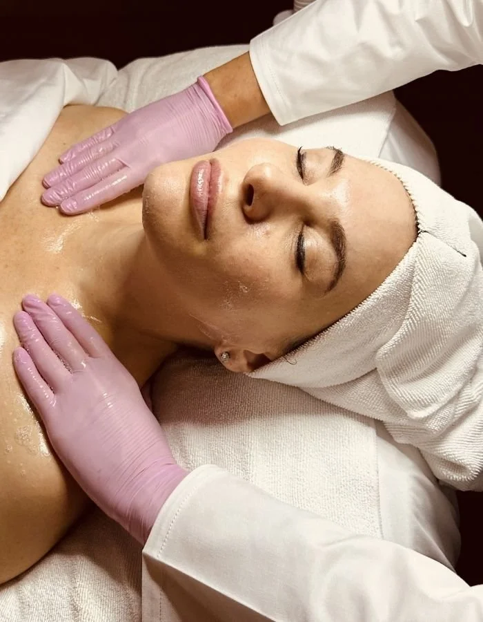 Female client receives a shoulder massage during a facial service