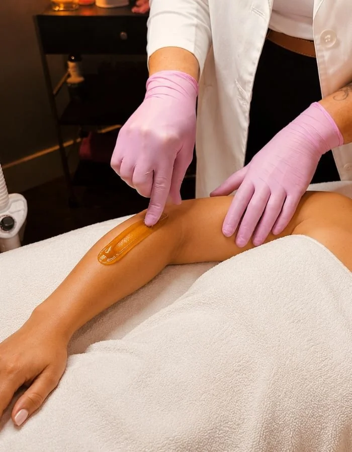Female client gets hair removal on her forearm