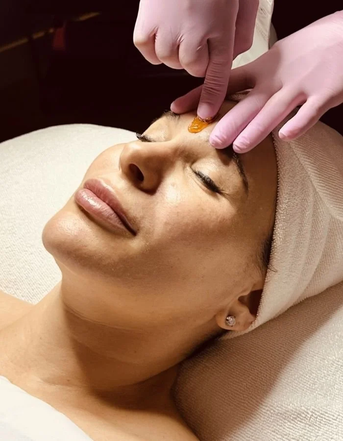 Female client receives a hair removal service with sugaring at Avila Skin Studio