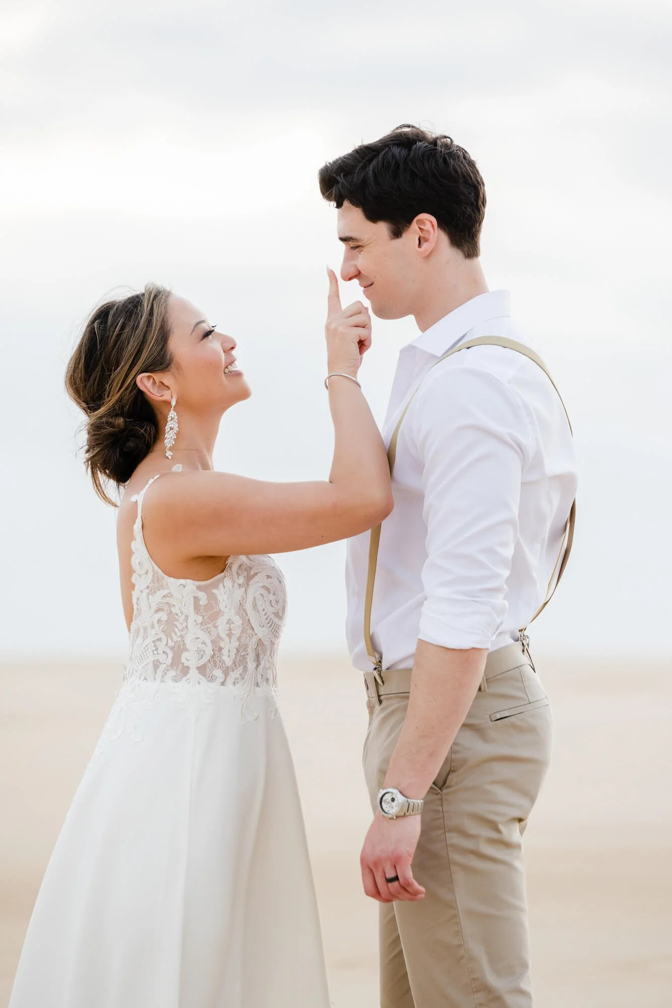 Sweet moment of a bride touching her new husband's nose, Anna Bay sand dunes, Port Stephens