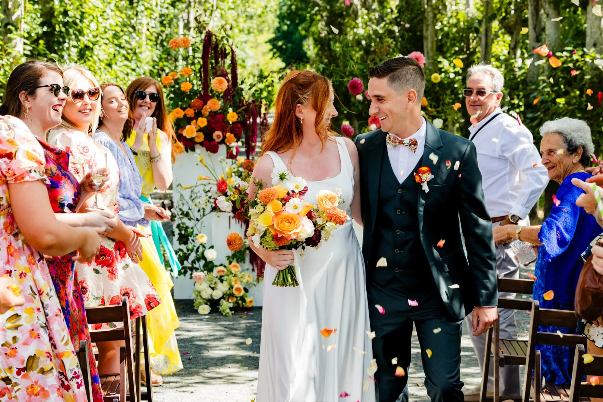 Bride and groom walking through confetti after their ceremony at Valhalla Restaurant, Port Stephens