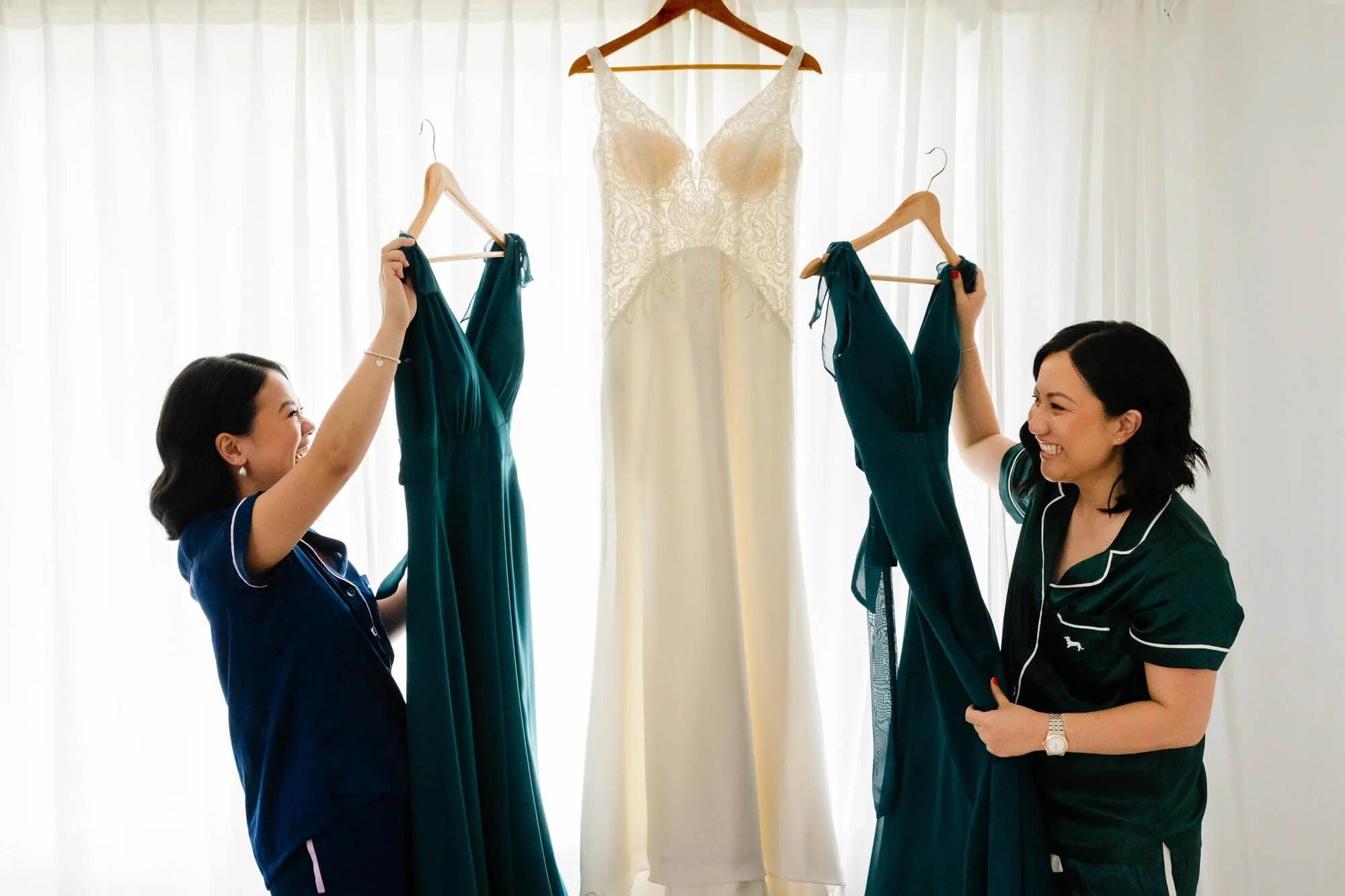 best-wedding-photography-two-bridesmaids-getting-dress.jpg