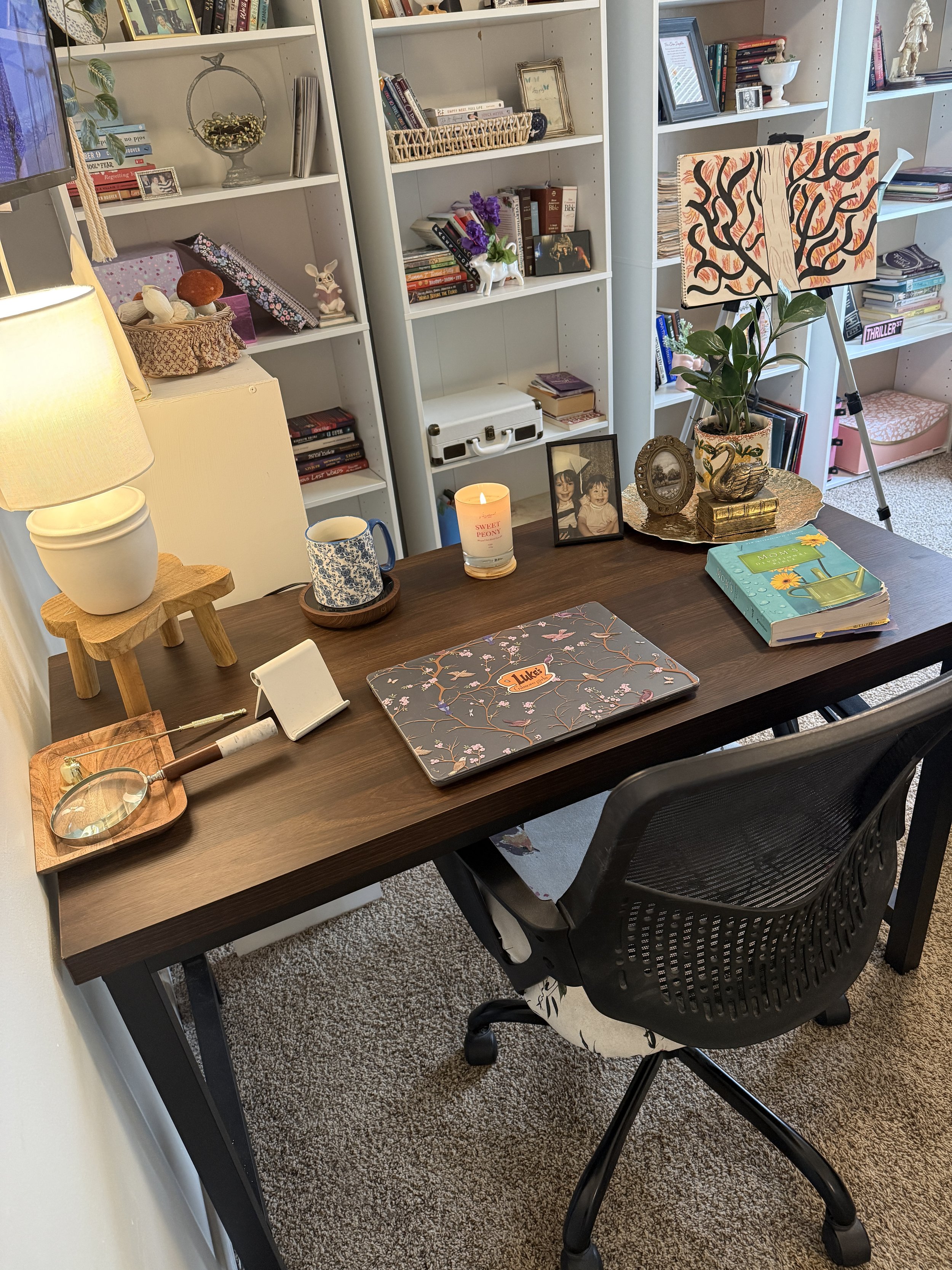 Cozy cottage home office with styled bookshelves, warm lighting, and desk setup