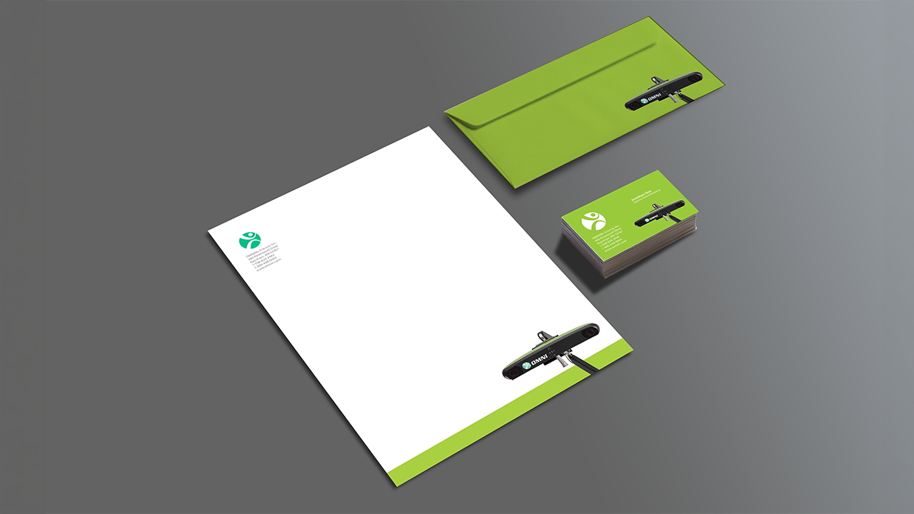 Business stationery set including a letterhead, business cards, and a folder with a laser measuring tool on a gray surface.