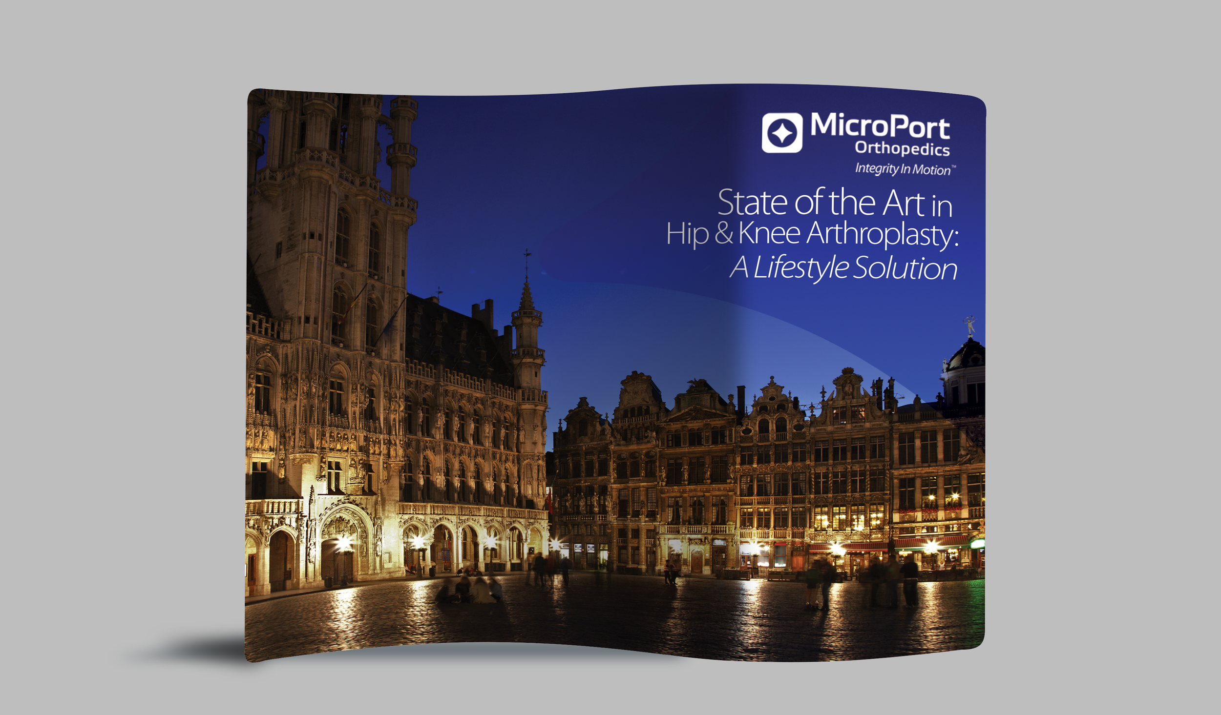 A digitally designed brochure featuring a night view of historic European-style buildings illuminated, with the title 'State of the Art in Hip & Knee Arthroplasty: A Lifestyle Solution' and the logo of MicroPort Orthopedics.
