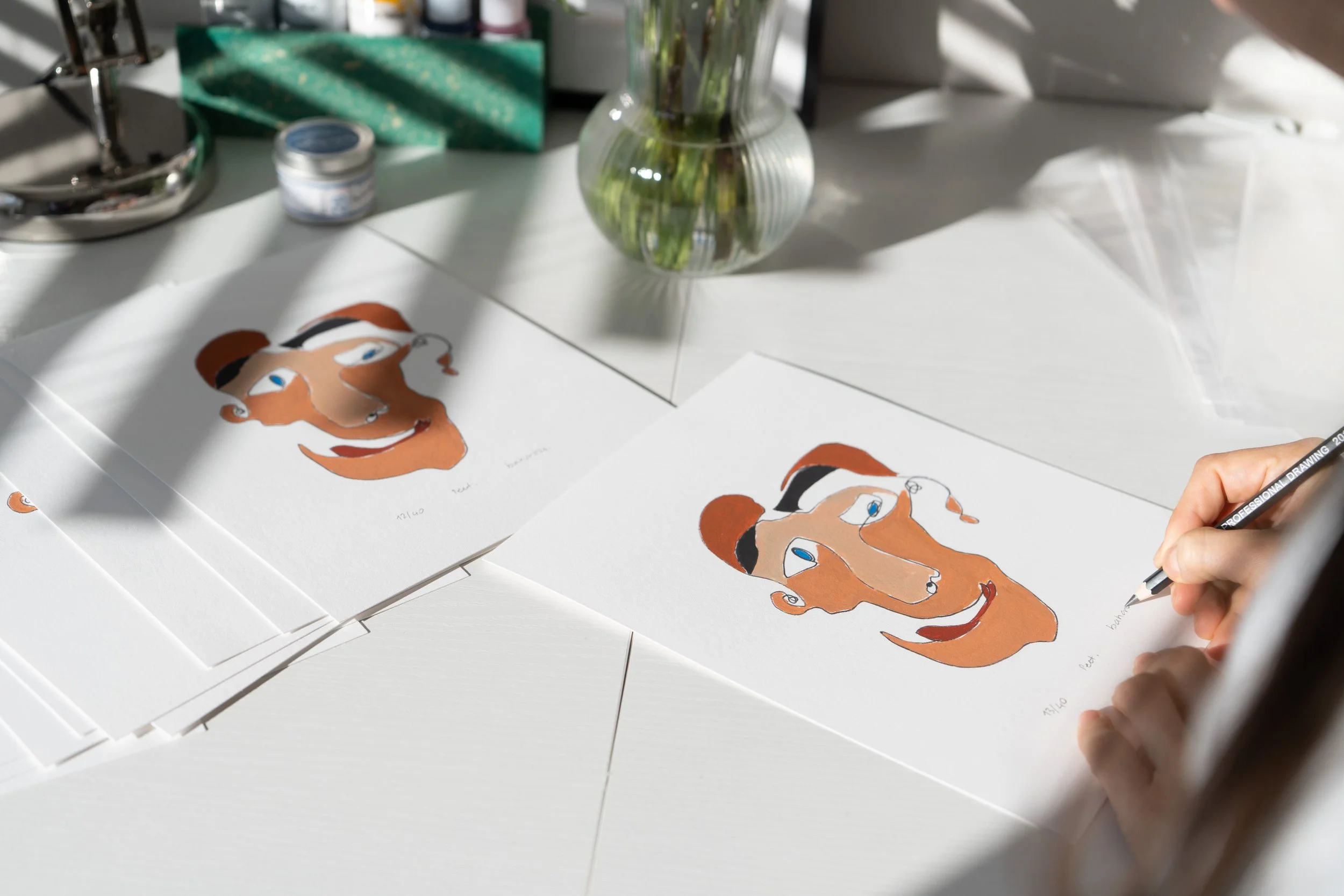 Person drawing a stylized portrait of a woman with brown hair and blue eyes on white paper with colored markers in the background.