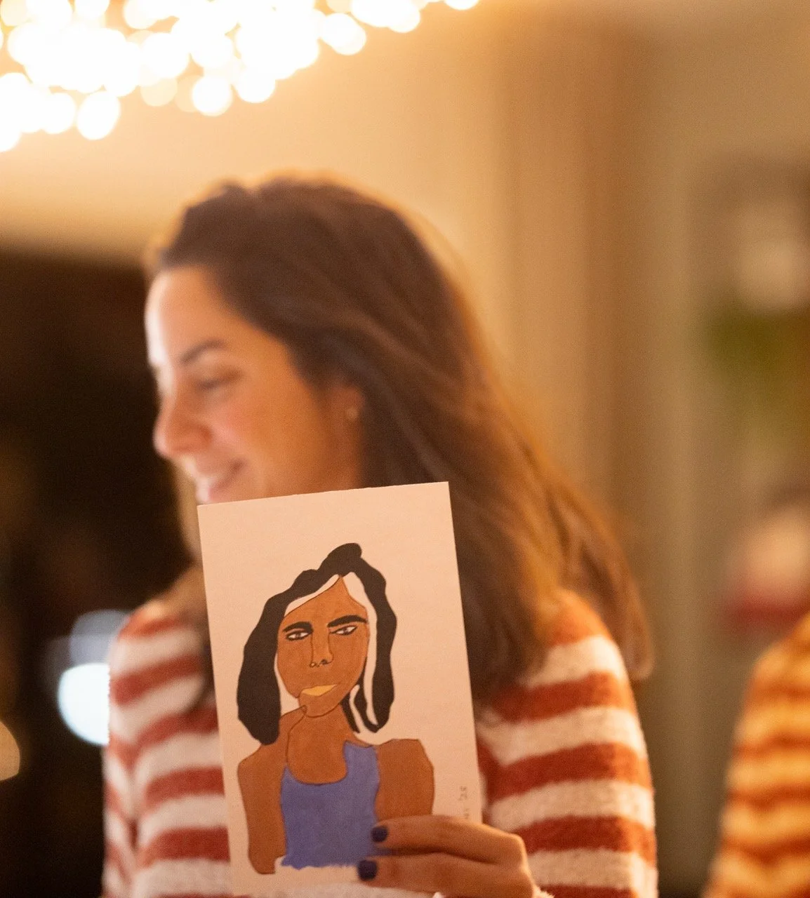 artist baharozs holding her painting named Asli