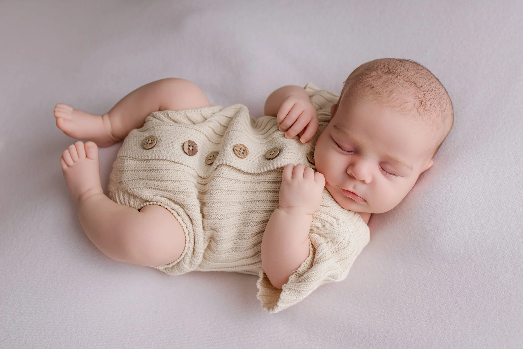 Baby girl sleeping in a Little B's Nursery outfit at her Newborn Family photoshoot in Melbourne