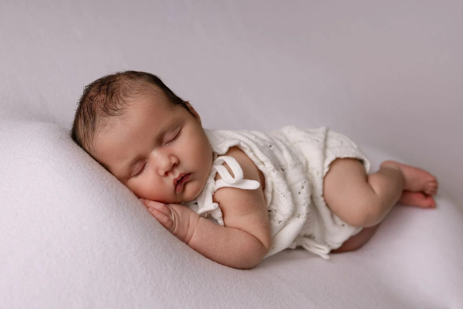 Newborn baby sleeping peacefully during a studio photography session in Melton