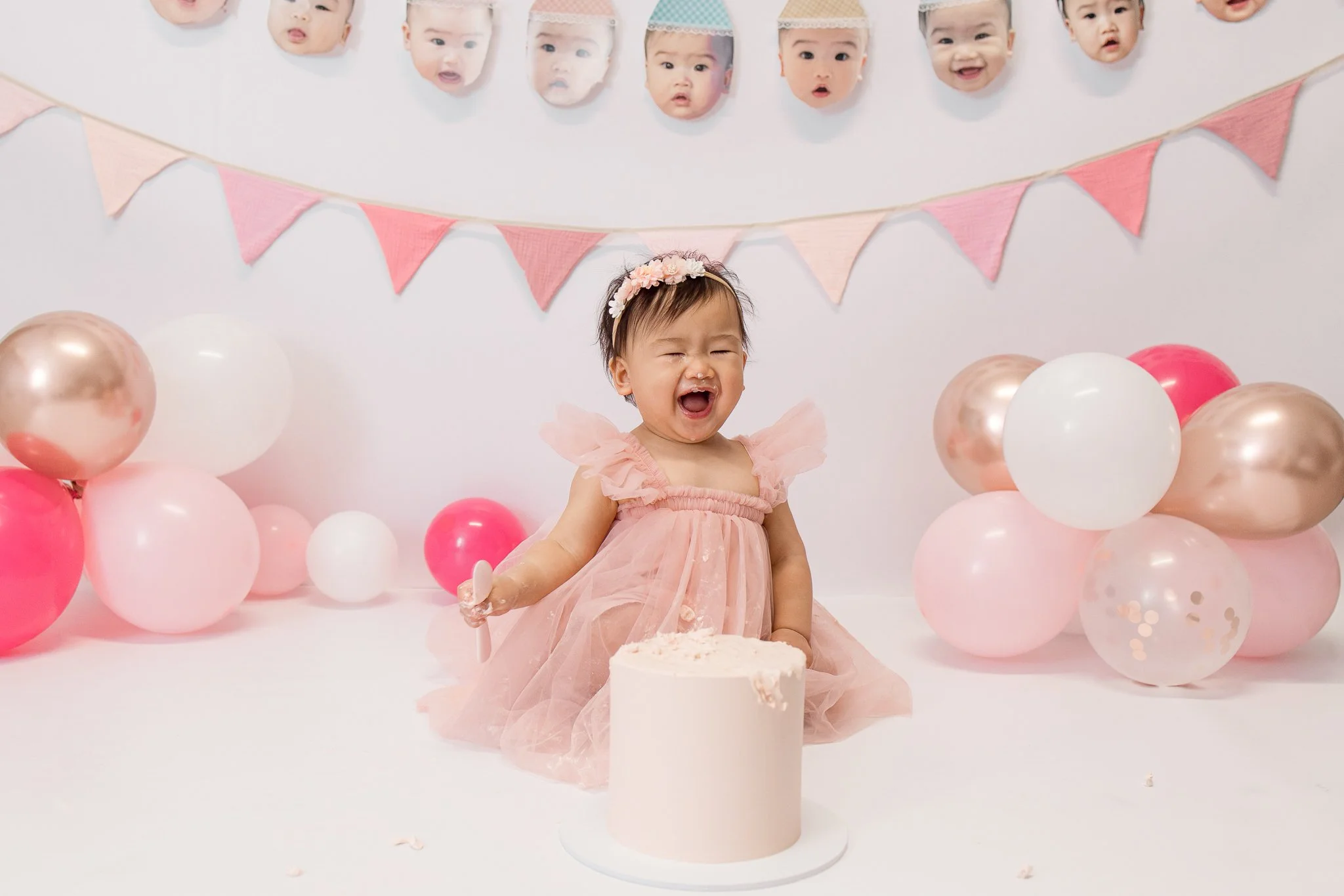 Toddler cake smash photography session with yellow dress and pink balloons Melbourne