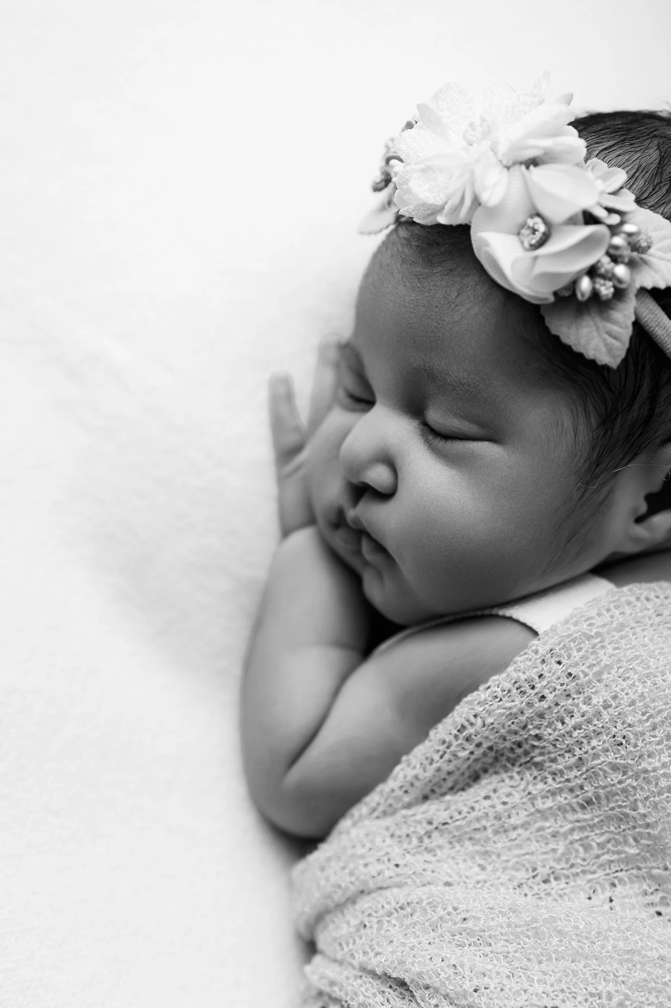 Close up of Newborn baby sleeping in a neutral wrap during a studio photography session in Melton