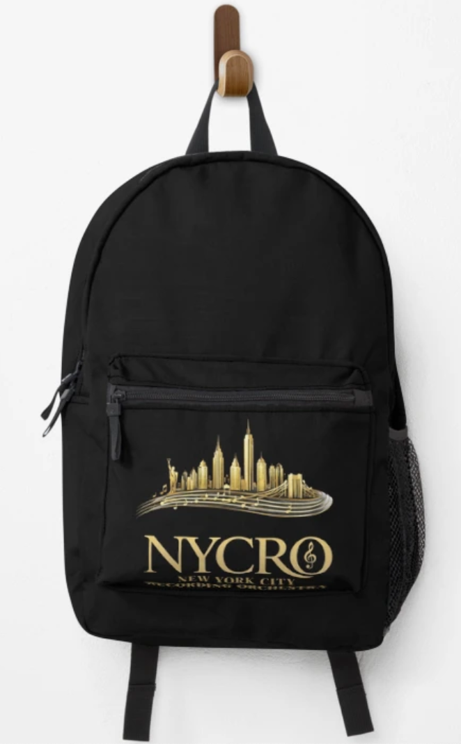 Black backpack with a gold city skyline and text reading 'NYCRO, New York City' hanging on a wooden hook against a white wall.