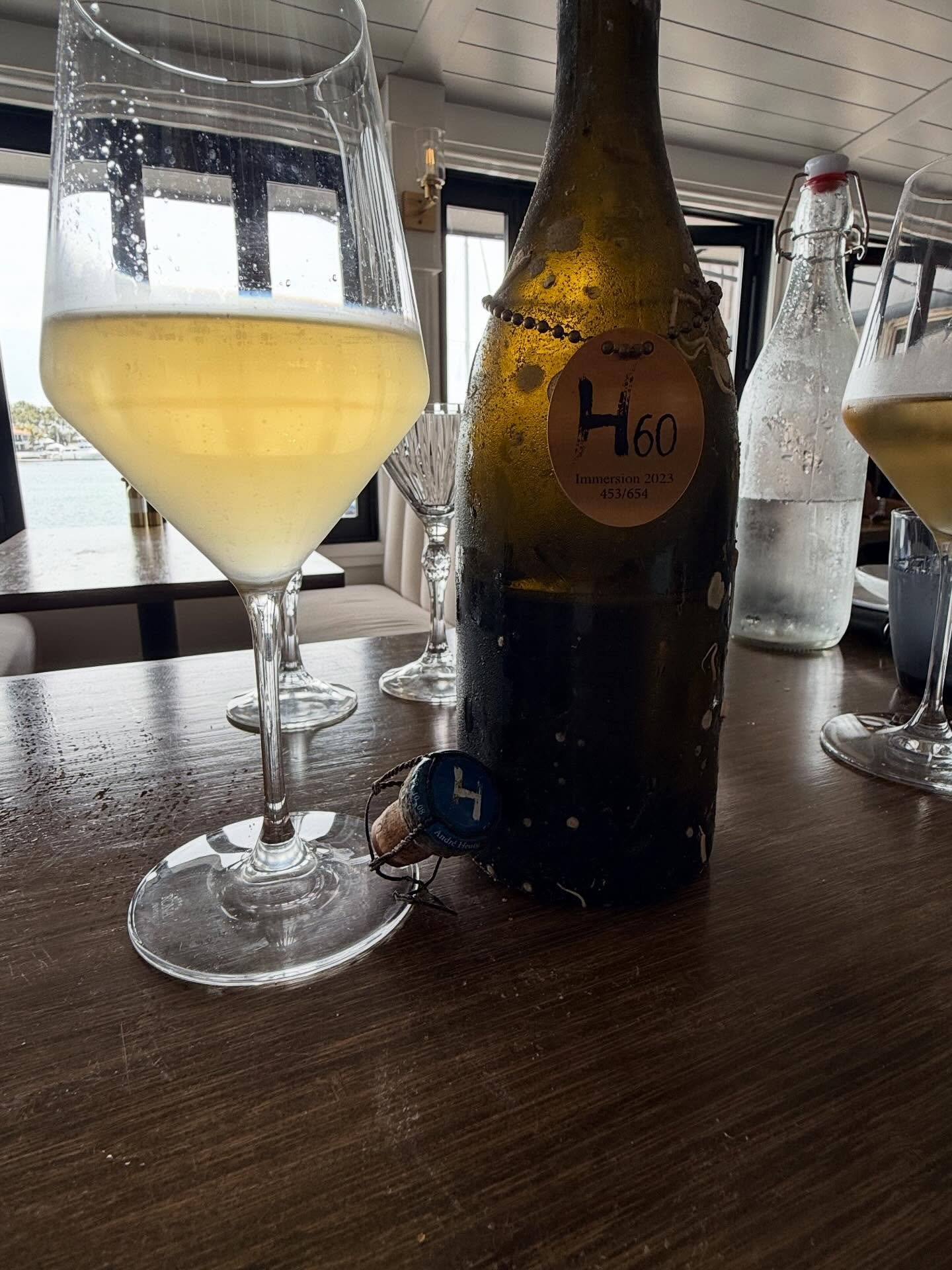 @champagneandreheucq 

 H60 Immersion 2023

Bottle Number: 453 / 654
Producer: Andr&eacute; Heucq
Region: Vall&eacute;e de la Marne, Champagne, France
Village: Cuisles
Classification: Brut Nature Grower Champagne

Grape Variety

100% Pinot Meunier

H