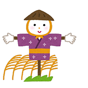 かかしの人形。紫色の着物を着て、わらの台に立っている。