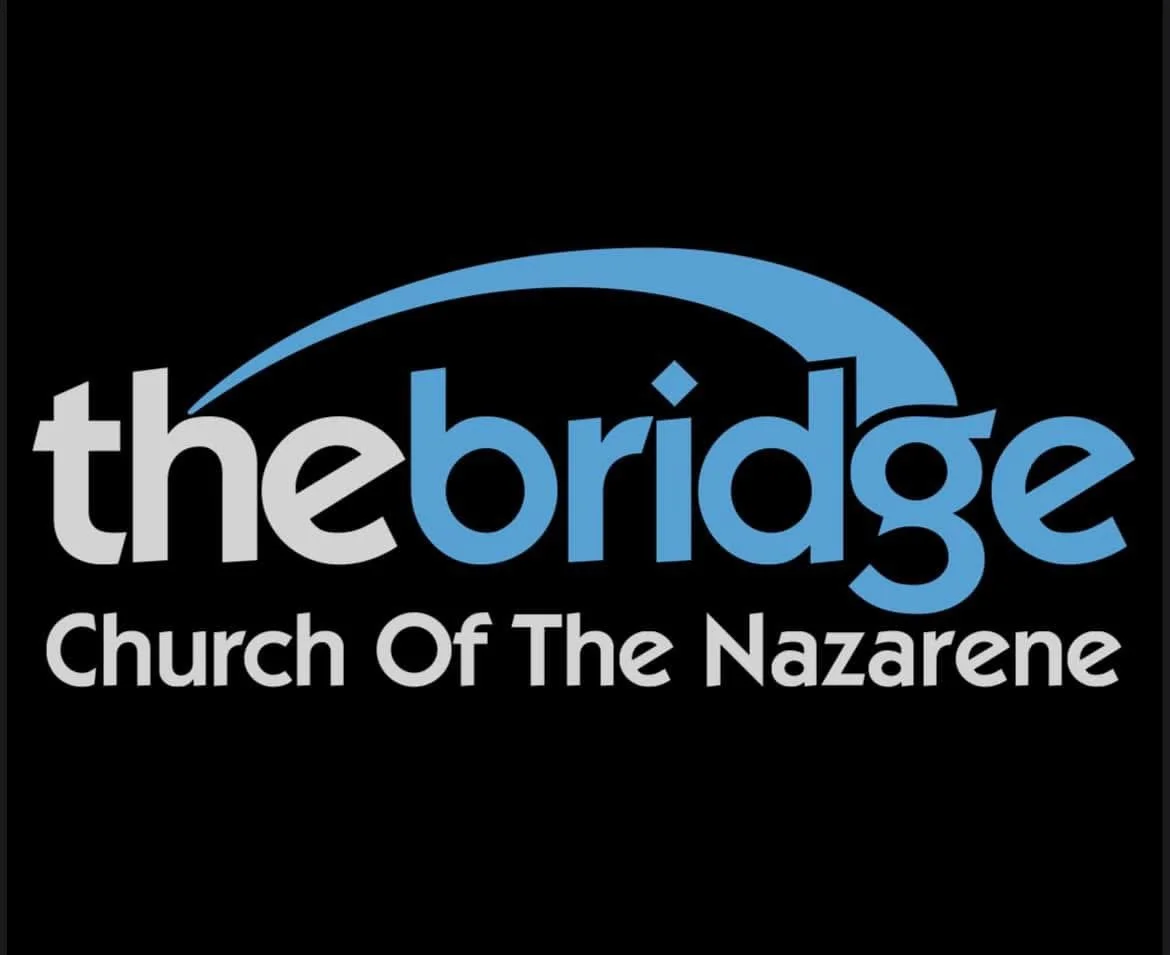 Logo for The Bridge Church of the Nazarene, featuring a stylized blue bridge above the text on a black background.