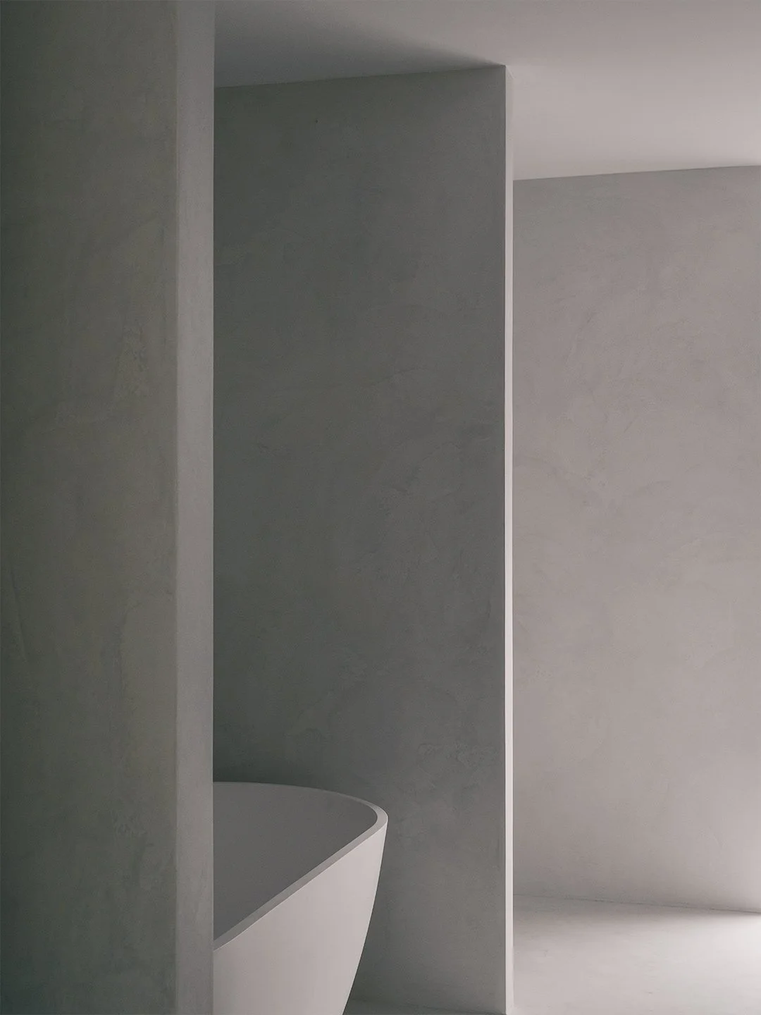 Modern bathroom with micro cement and natural light.