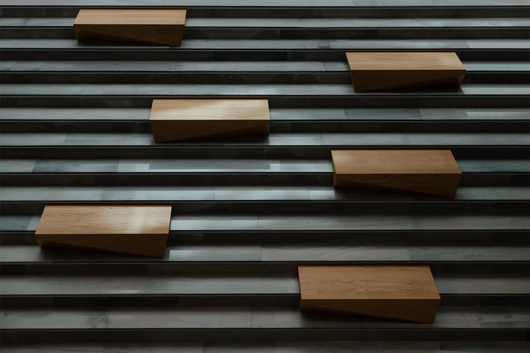 Architectural staircase with custom wooden block seating in contemporary public space, Uppsala Sweden.