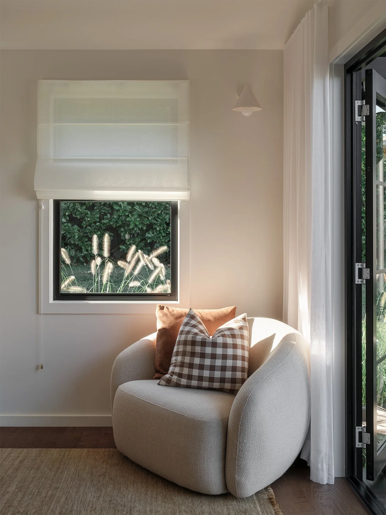 Designer sofa in corner of room with natural light raking over.