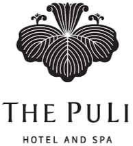Logo of The Puli Hotel and Spa featuring a black floral pattern above the text.