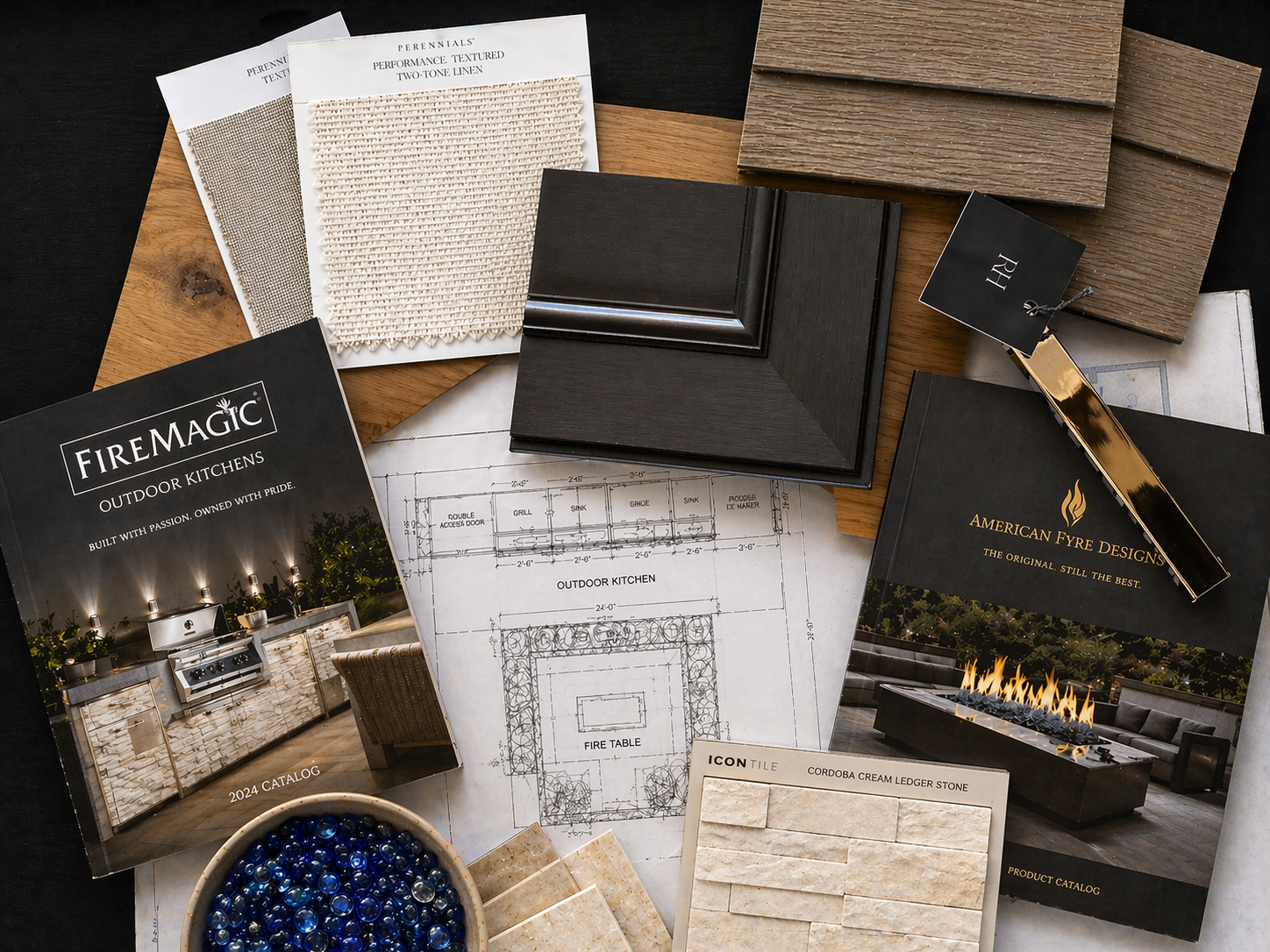 Sample materials for building a kitchen, including color and texture samples, design catalogs, and blueprints.