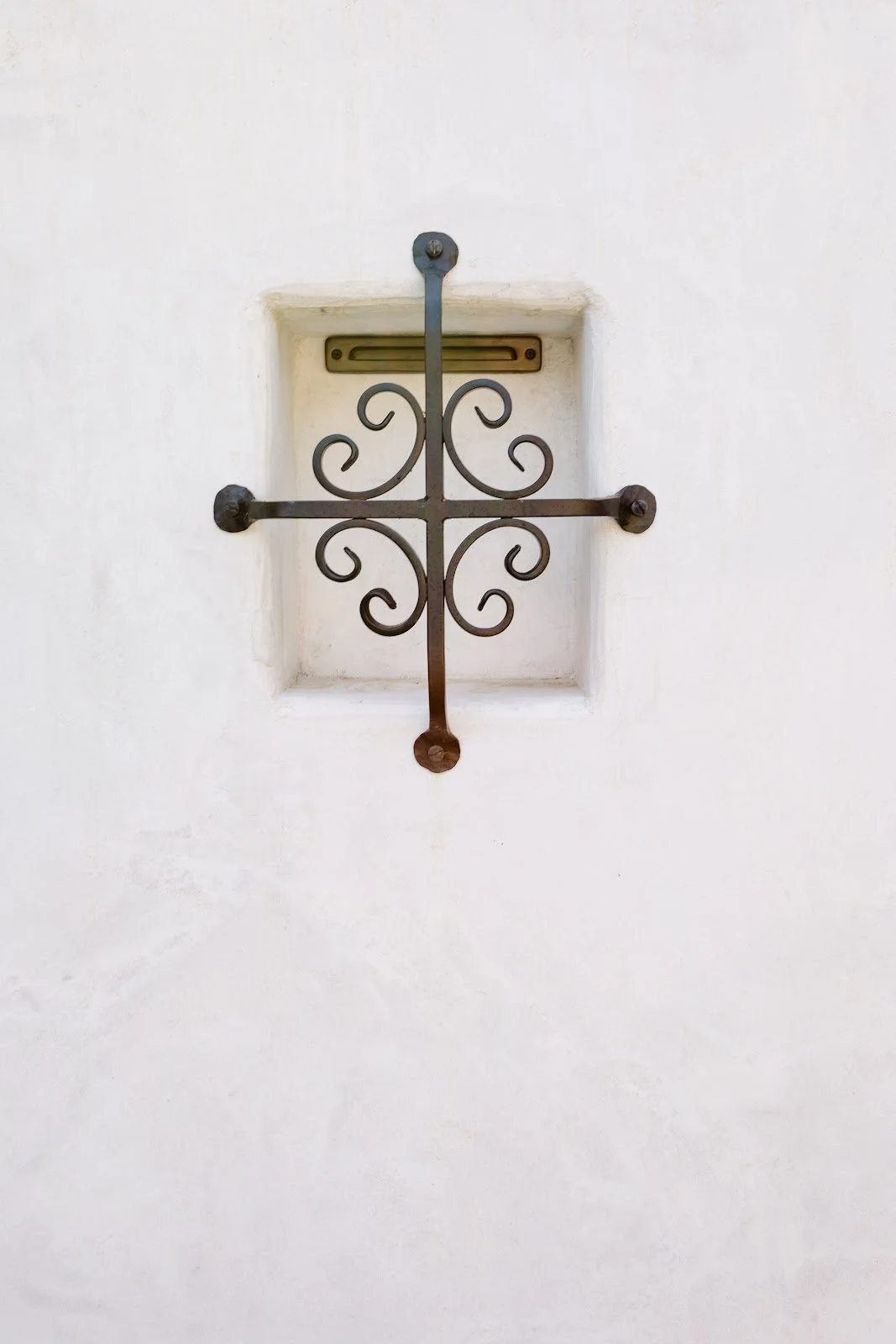 Decorative iron wall tie on the Spanish-style addition
