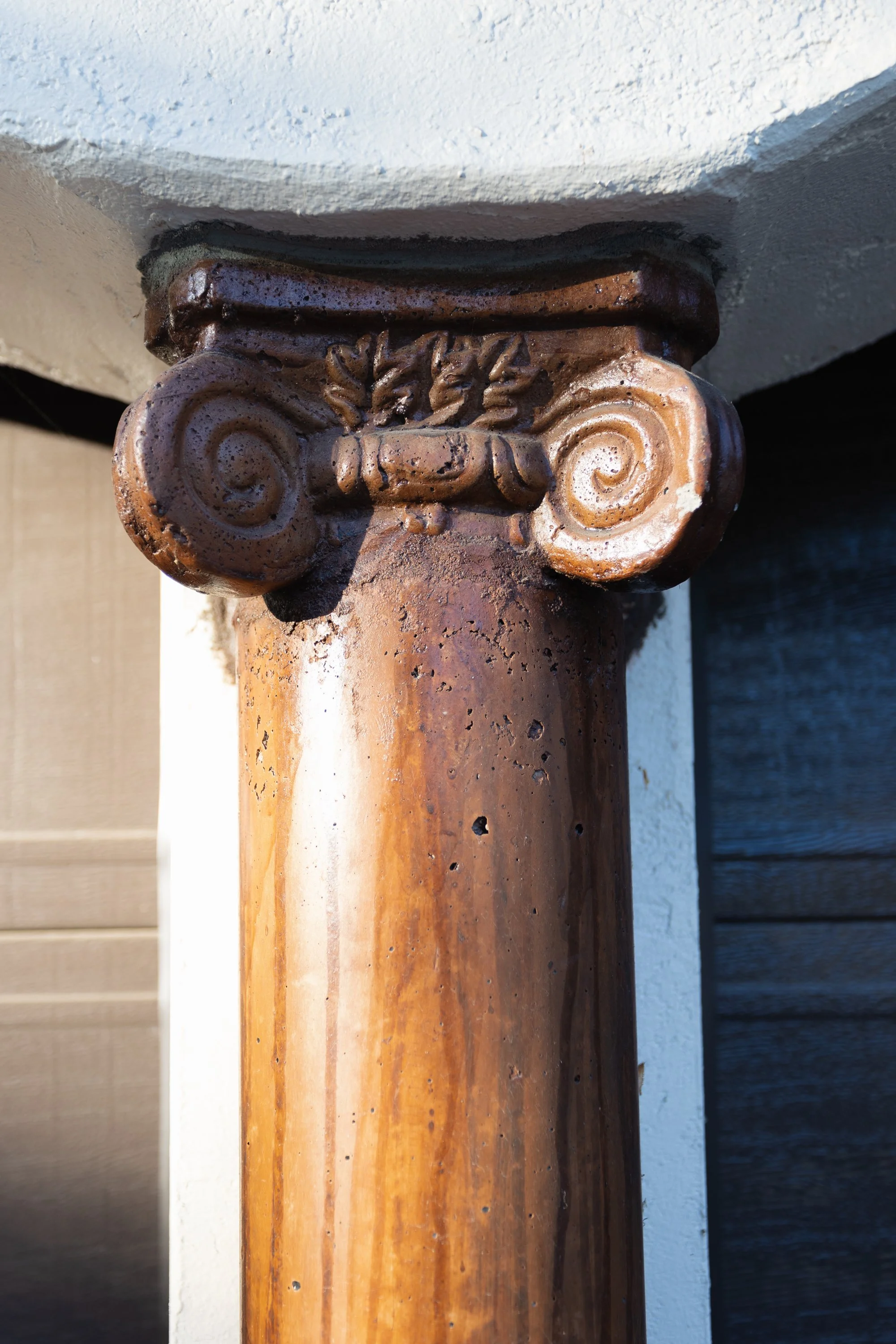 Carved wood column capital matching the home’s historic details