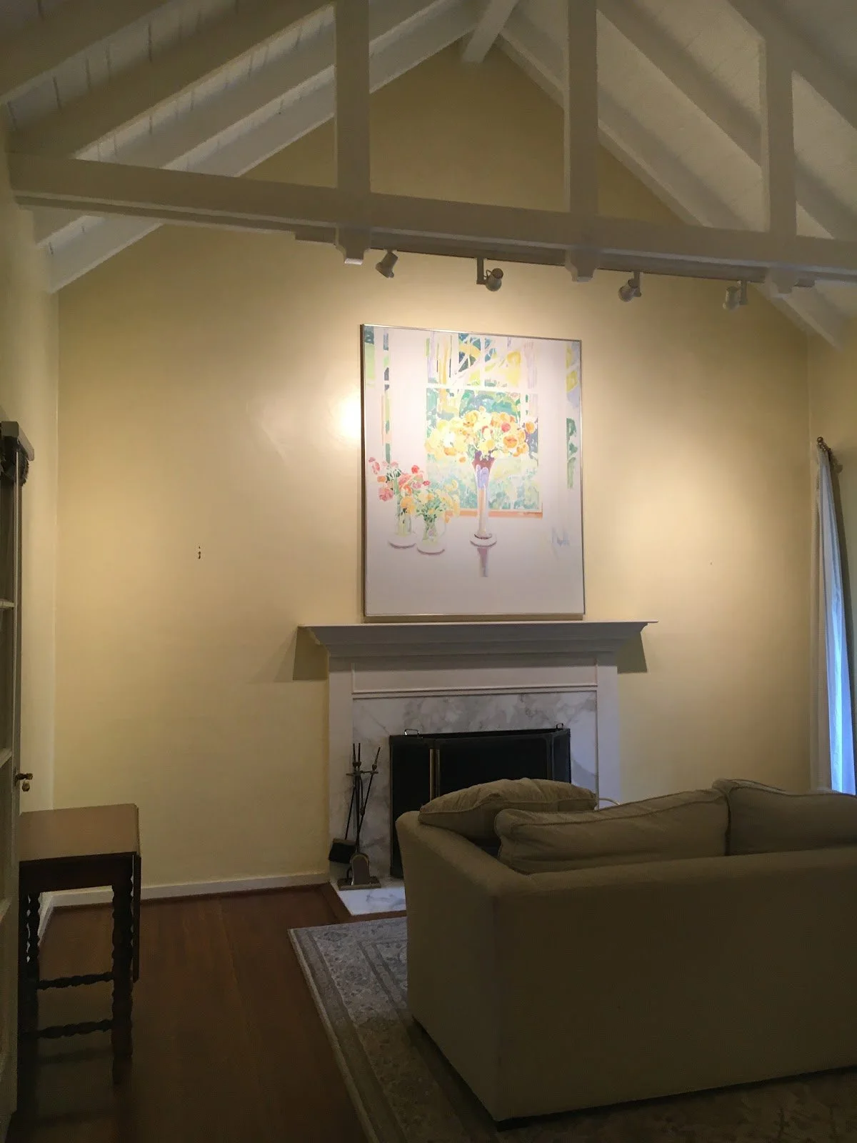 Living room fireplace and artwork before renovation
