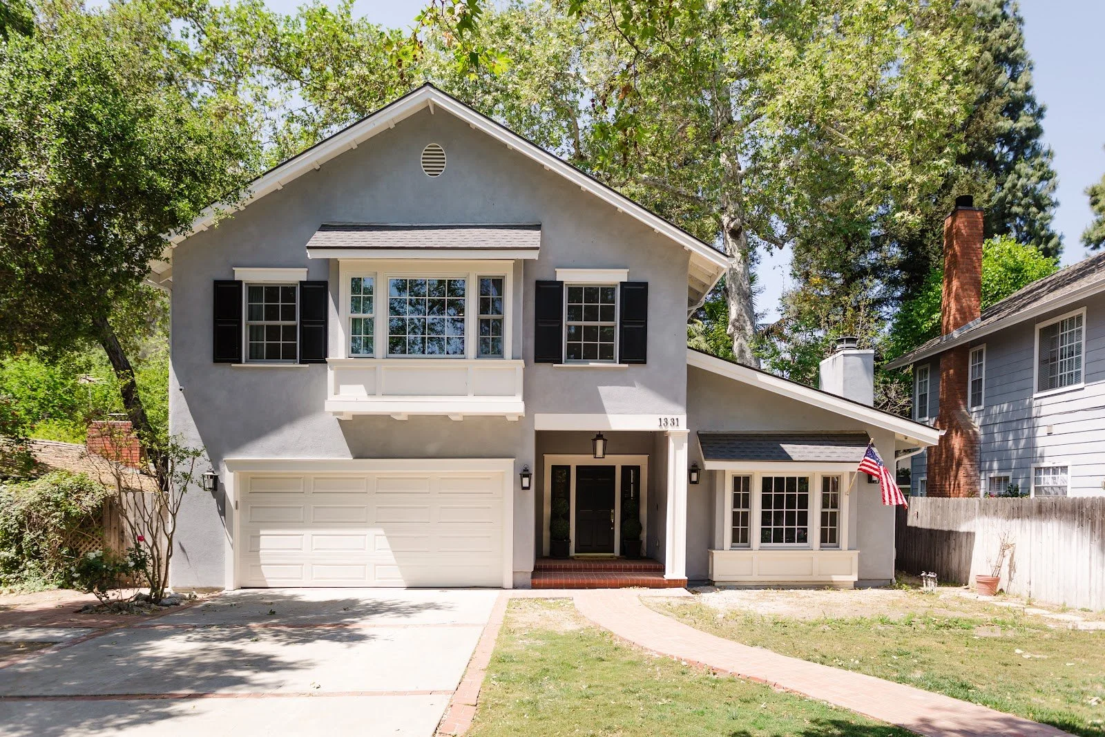 The Hinkley House exterior with a gabled roof and mature trees