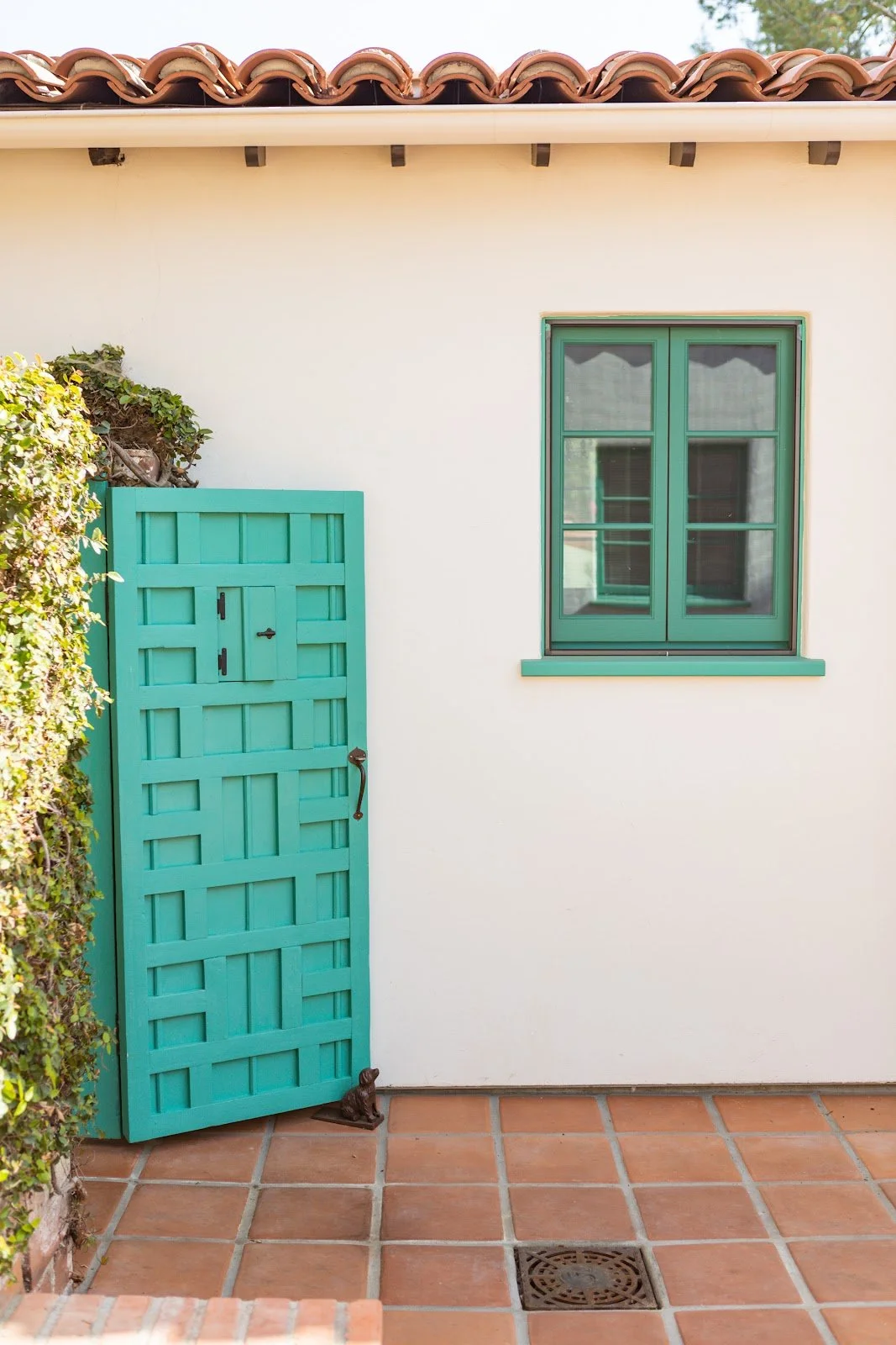 Turquoise wood door and window on the Spanish-style courtyard