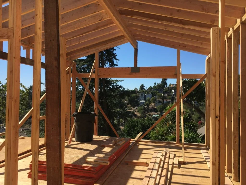 Residential wood framing under construction on a hillside