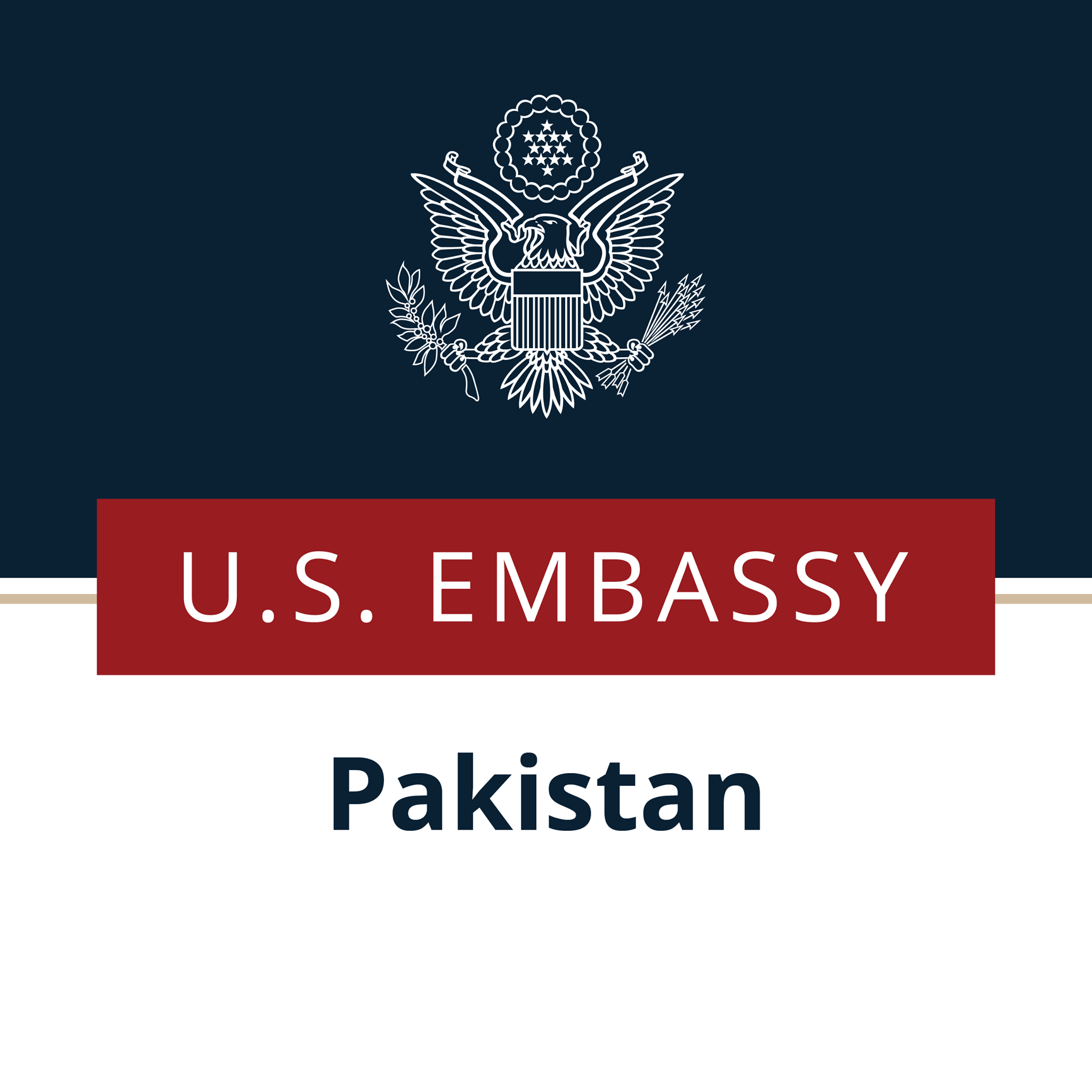 U.S. Embassy Pakistan logo featuring a white outline of the emblem on a dark background with the words 'U.S. Embassy Pakistan' in white letters on a red and white banner at the bottom.