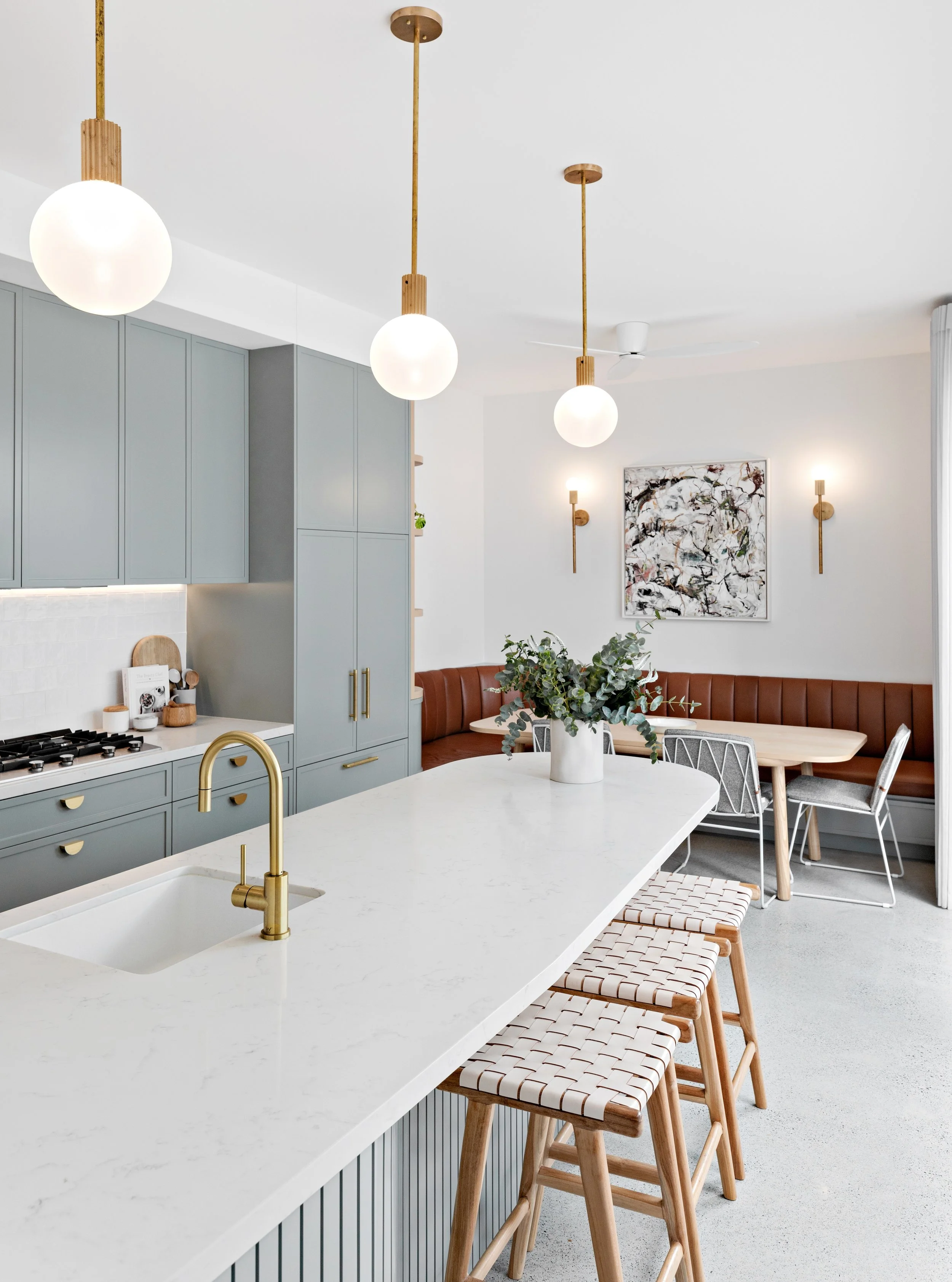 Sage green kitchen with leather banquette