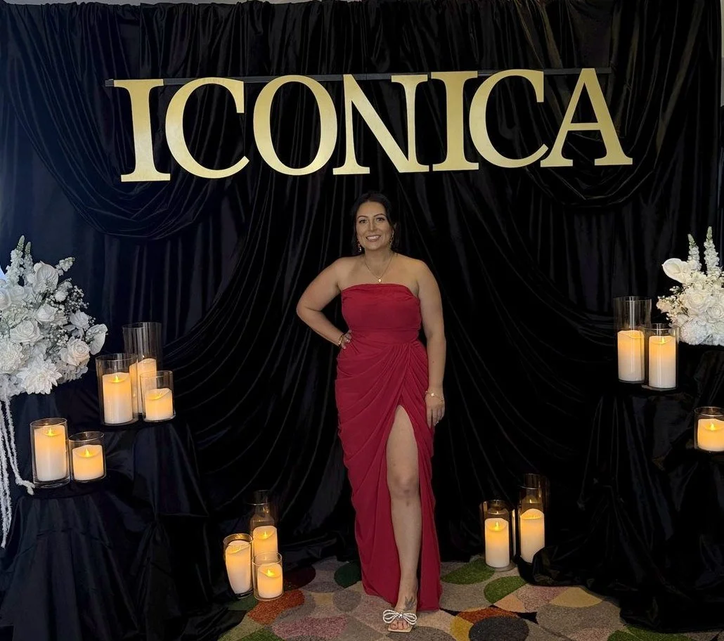 Catherine Turner with her black velvet draping, gold signage and white floral styling for the Iconica brand event