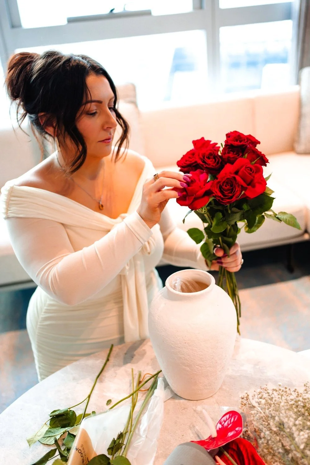 Catherine Turner, event stylist and owner of Social Soirée Society, arranging red roses