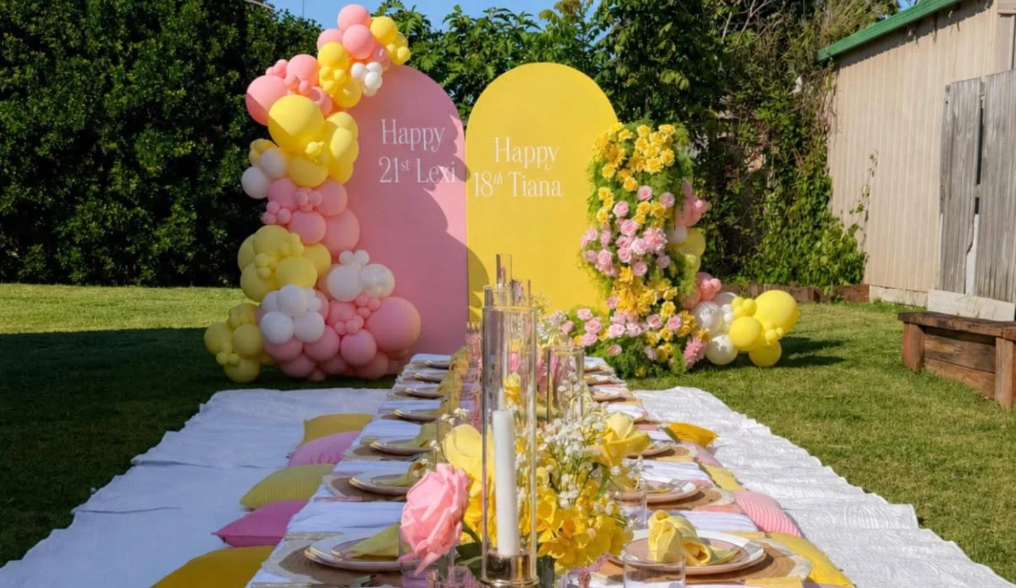 Luxury picnic long table with pink and yellow balloon backdrop, Redland Bay