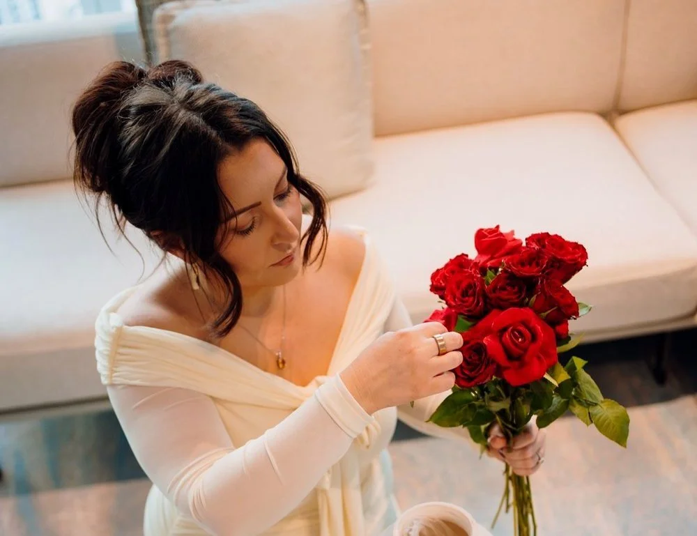Catherine Turner of Social Soirée Society styling a red rose floral arrangement