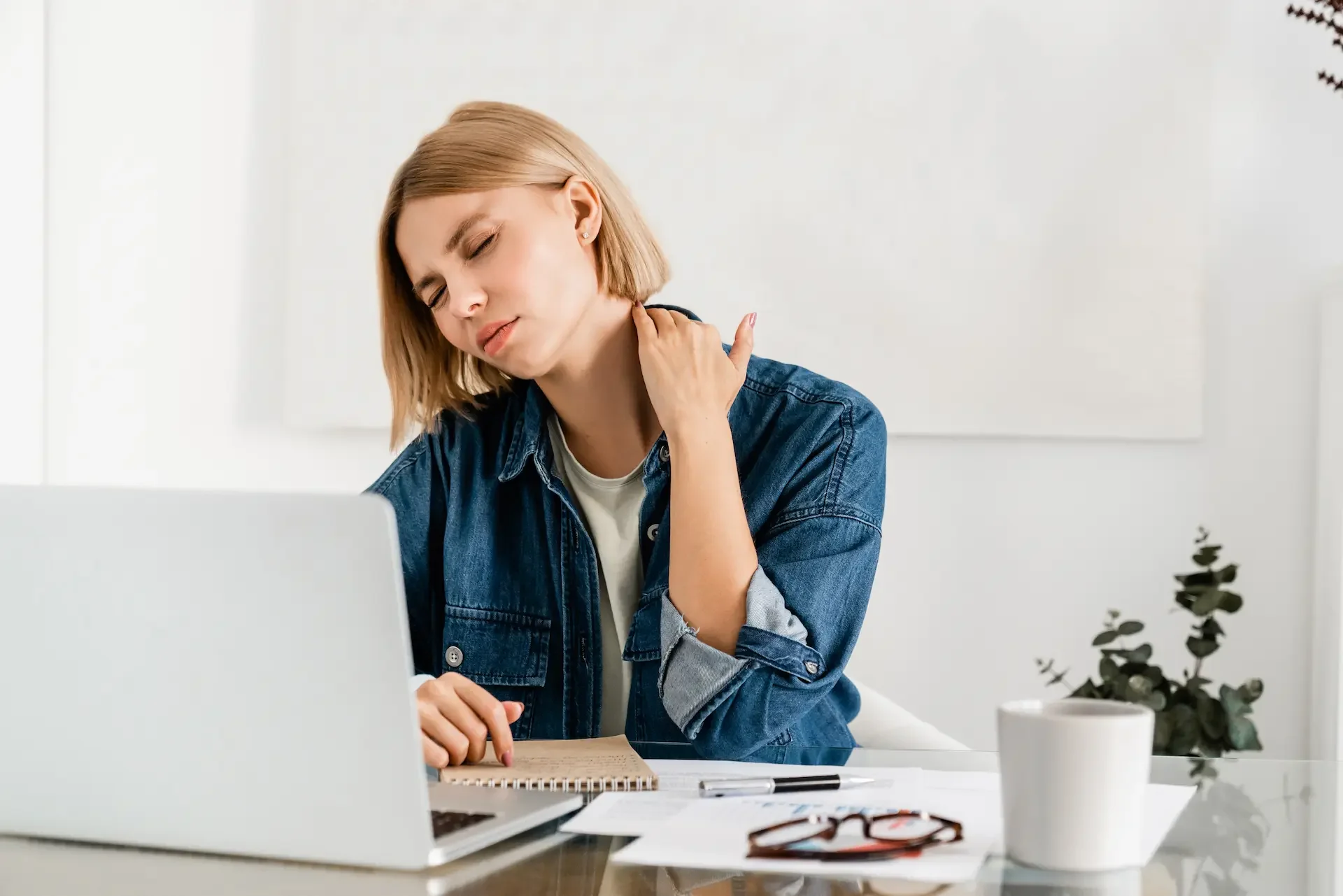 Person with neck and shoulder pain from desk work in Nelson